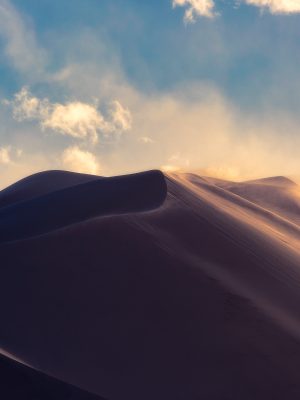 A Windy Day Golden dunes under a cloudy sky